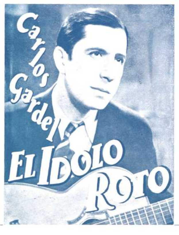 Ein Plakat, das El Idolo Roro, einen spanischen S├Ąnger-Schreiber, mit einer Gitarre in der Hand zeigt, der ein wei├čes Hemd und einen schwarzen Anzug tr├Ągt, mit zur├╝ckgek├Ąmmtem Haar und einem ernsten Gesichtsausdruck, vor einem hellblauen Hintergrund mit fetter schwarzer Schrift.