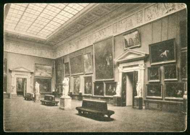 Ein Schwarz-Weiß-Foto eines großen Raums mit Skulpturen, Bänken und Foto-Rahmen an den Wänden sowie einer Decke mit einem Dachfenster, das möglicherweise die Nationalgalerie in London zeigt.