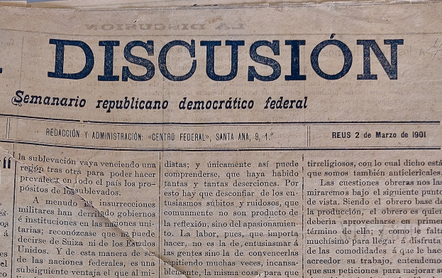 Eine gelbliche, leicht zerknitterte Zeitung mit der schwarzen Schrift 'Diskussion' darauf, mit der Überschrift 'Semanario Repúblicano Democrático Federal'.
