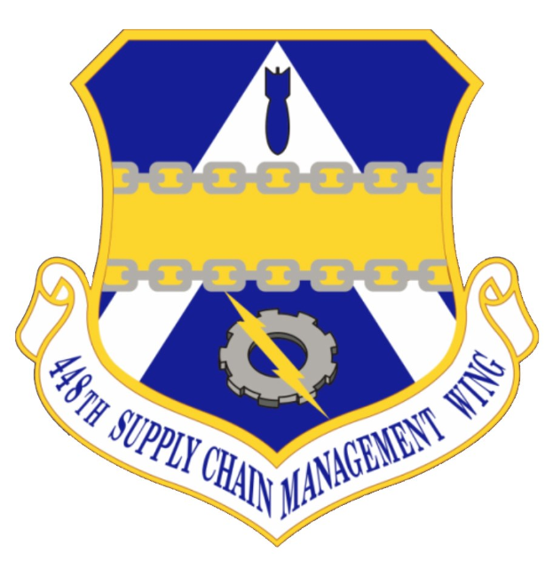 Logo des 48. Versorgungsgeschwader mit einem blauen Schild mit einem weißen Stern und einem weißen Banner mit der Aufschrift "Versorgungsgeschwader" in blau, alles von einem weißen Rand umgeben und "48. Versorgungsgeschwader" in fetter schwarzer Schrift darunter.